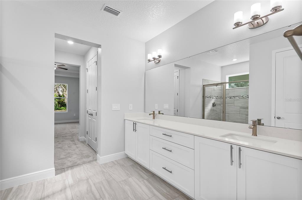 304 North Jungle Road Geneva, FL 32732 - Photo 27 of 49 a spacious bathroom with double sink and a mirror