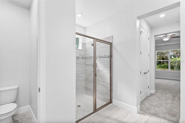 a bathroom with a shower and toilet