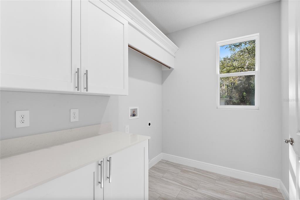 304 North Jungle Road Geneva, FL 32732 - Photo 30 of 49 a kitchen with white cabinets and a window