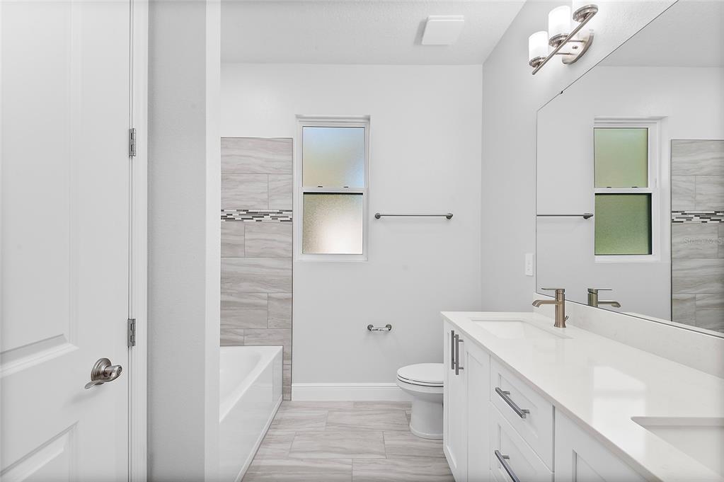 304 North Jungle Road Geneva, FL 32732 - Photo 35 of 49 a bathroom with a sink a toilet and shower