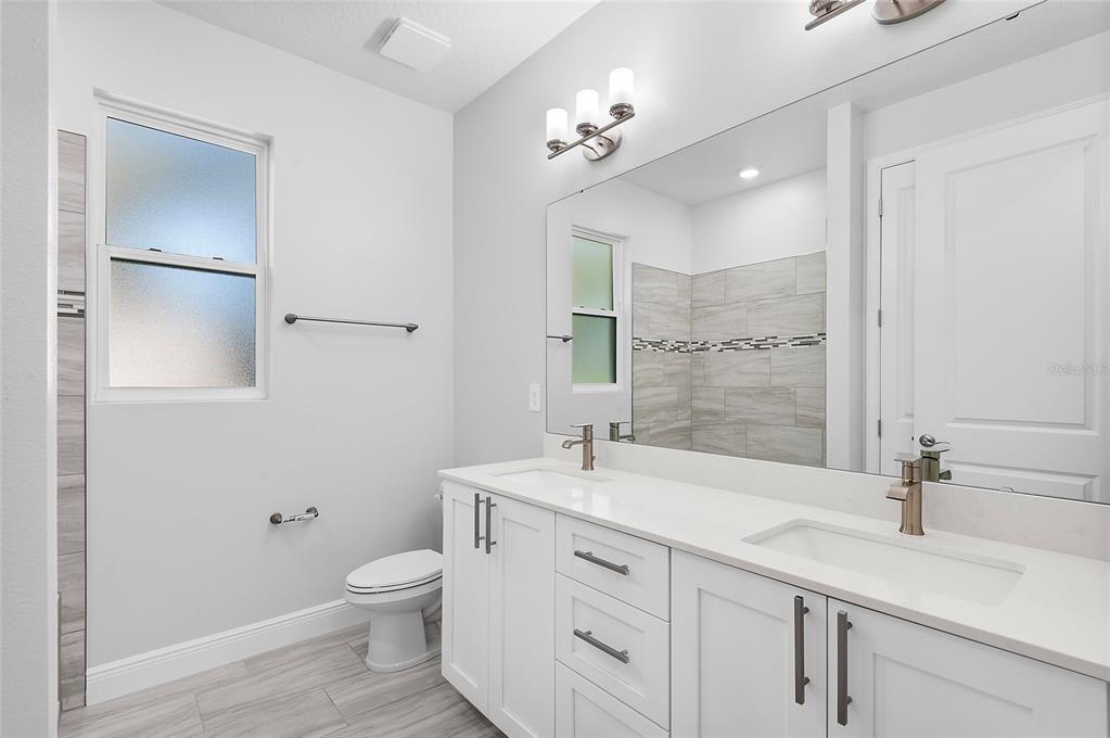 304 North Jungle Road Geneva, FL 32732 - Photo 36 of 49 a bathroom with a sink a toilet and a mirror