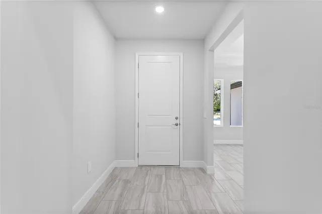 a view of a small space with wooden floor and a window