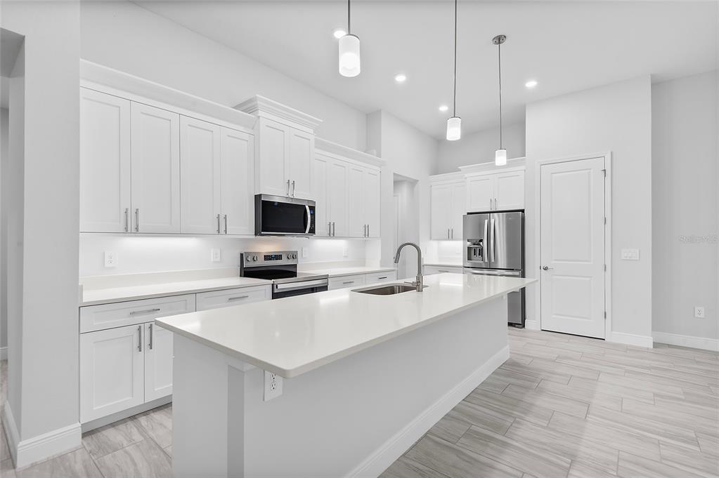 304 North Jungle Road Geneva, FL 32732 - Photo 5 of 49 a kitchen with stainless steel appliances a sink stove and refrigerator