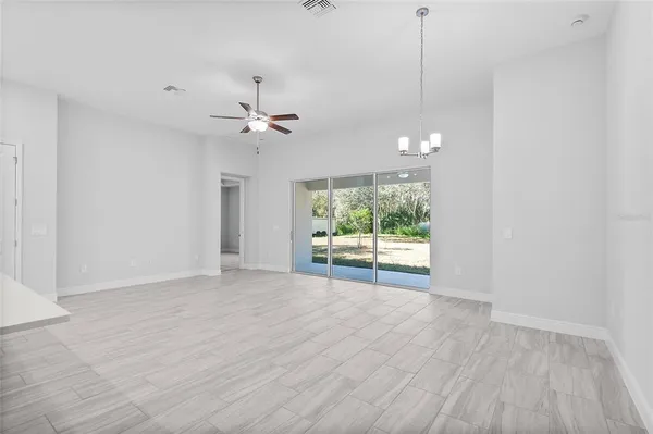 a large white kitchen with stainless steel appliances