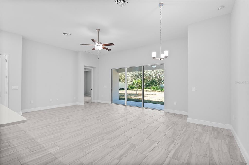 304 North Jungle Road Geneva, FL 32732 - Photo 10 of 49 a view of an empty room with a window and wooden floor