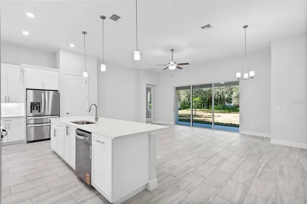 a large kitchen with cabinets and stainless steel appliances