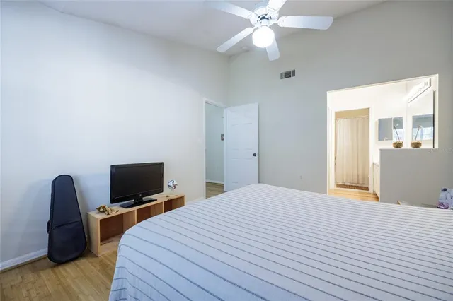 a bedroom with a bed and a flat screen tv