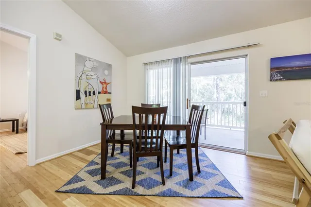 a view of a dining room with furniture wooden floor and a rug