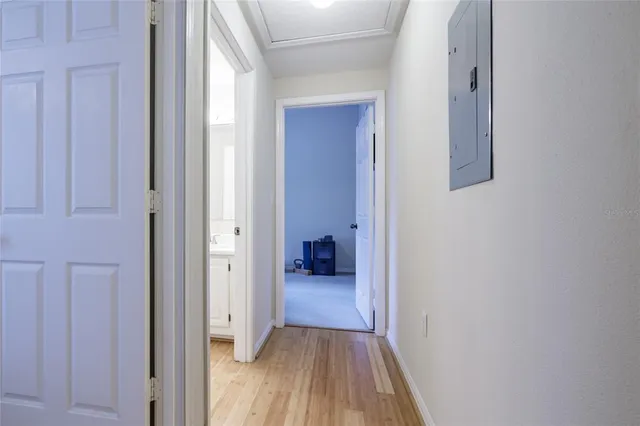 a view of a hallway with wooden floor and closet