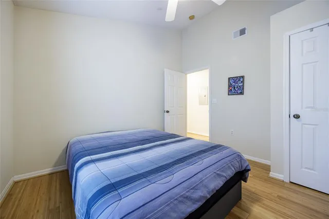 a bedroom with a bed and wooden floor