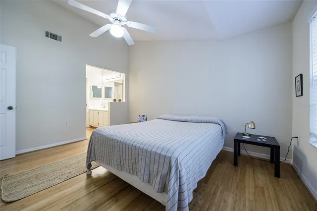 a bedroom with a bed table and a window