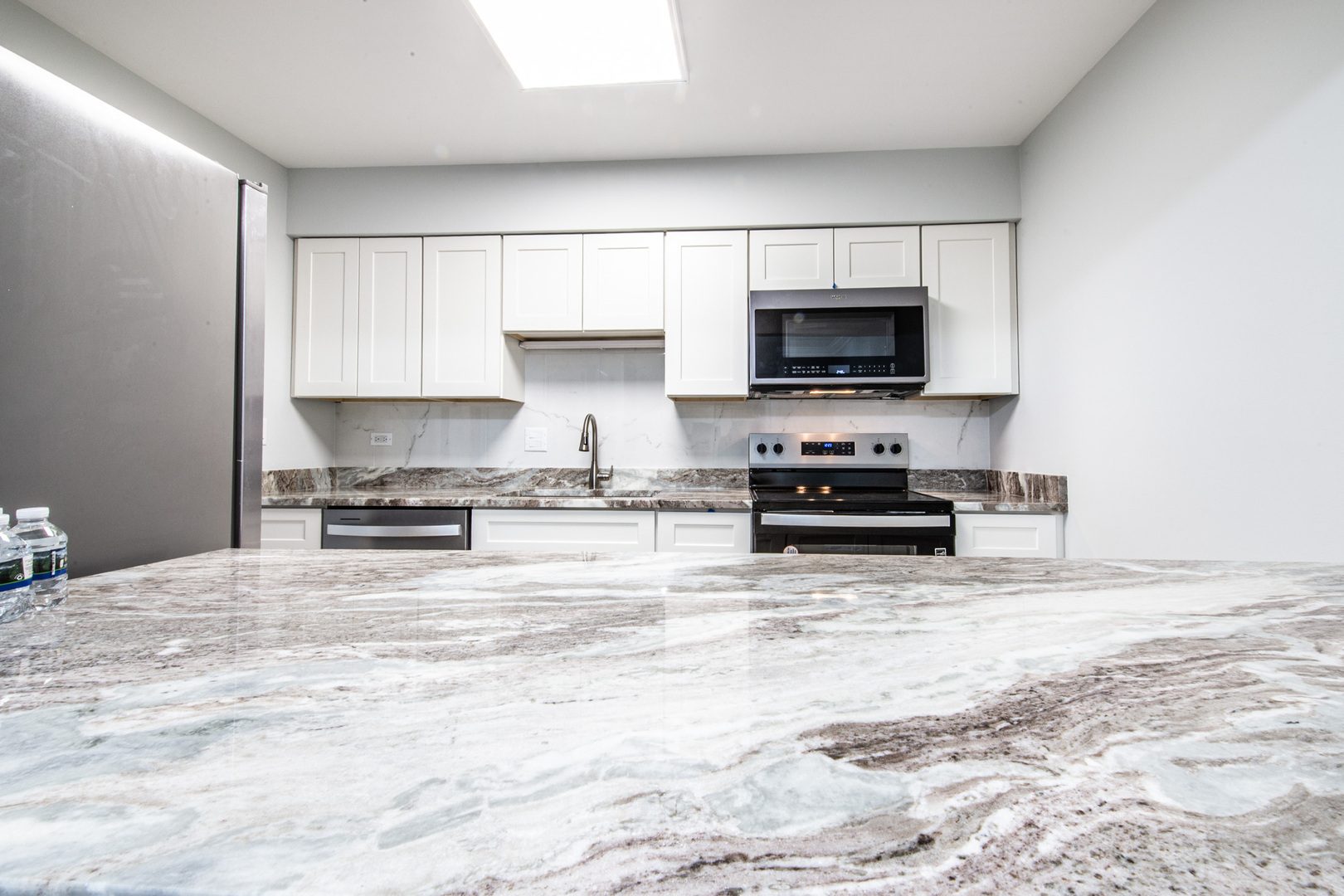 814 East Old Willow Road, Unit 109 Prospect Heights, IL 60070 - Photo 2 of 36 a kitchen with stainless steel appliances a stove a sink and a microwave