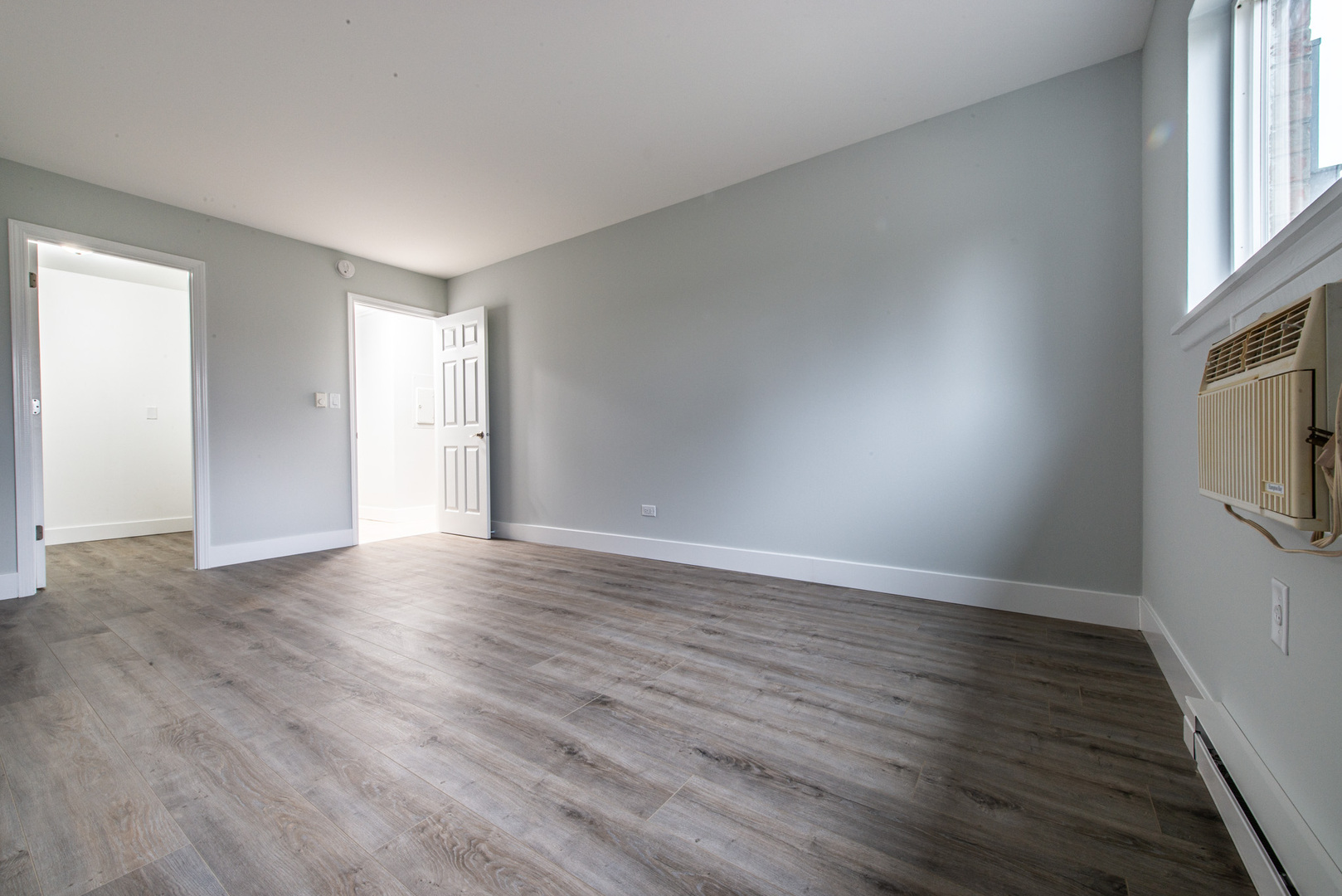 814 East Old Willow Road, Unit 109 Prospect Heights, IL 60070 - Photo 21 of 36 a view of an empty room with wooden floor and a window