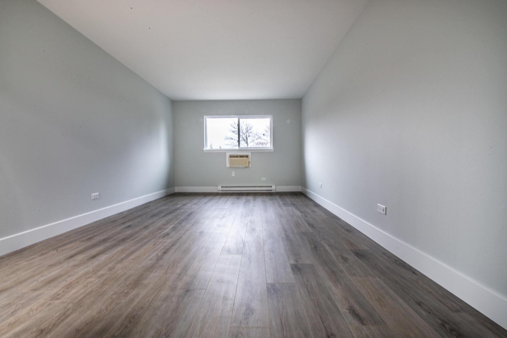 814 East Old Willow Road, Unit 109 Prospect Heights, IL 60070 - Photo 23 of 36 an empty room with wooden floor and windows