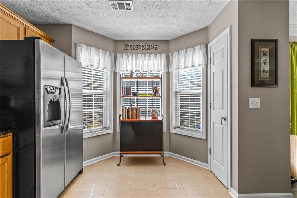 202 Weatherstone Crossing Woodstock, GA 30188 - Photo 14 of 29 a view of a kitchen with furniture and a window