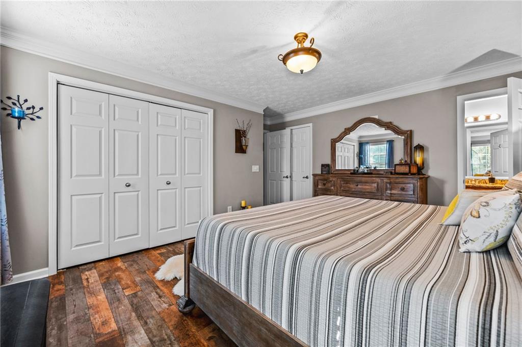 202 Weatherstone Crossing Woodstock, GA 30188 - Photo 17 of 29 a bedroom with a bed and a chandelier