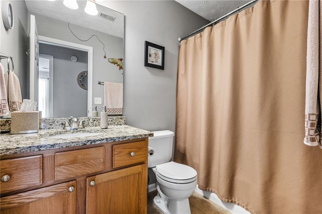 202 Weatherstone Crossing Woodstock, GA 30188 - Photo 23 of 29 a bathroom with a granite countertop sink and a mirror