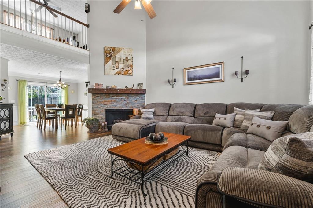 202 Weatherstone Crossing Woodstock, GA 30188 - Photo 5 of 29 a living room with furniture a rug and a fireplace