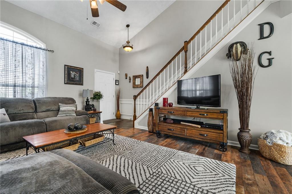 202 Weatherstone Crossing Woodstock, GA 30188 - Photo 8 of 29 a living room with furniture and a flat screen tv