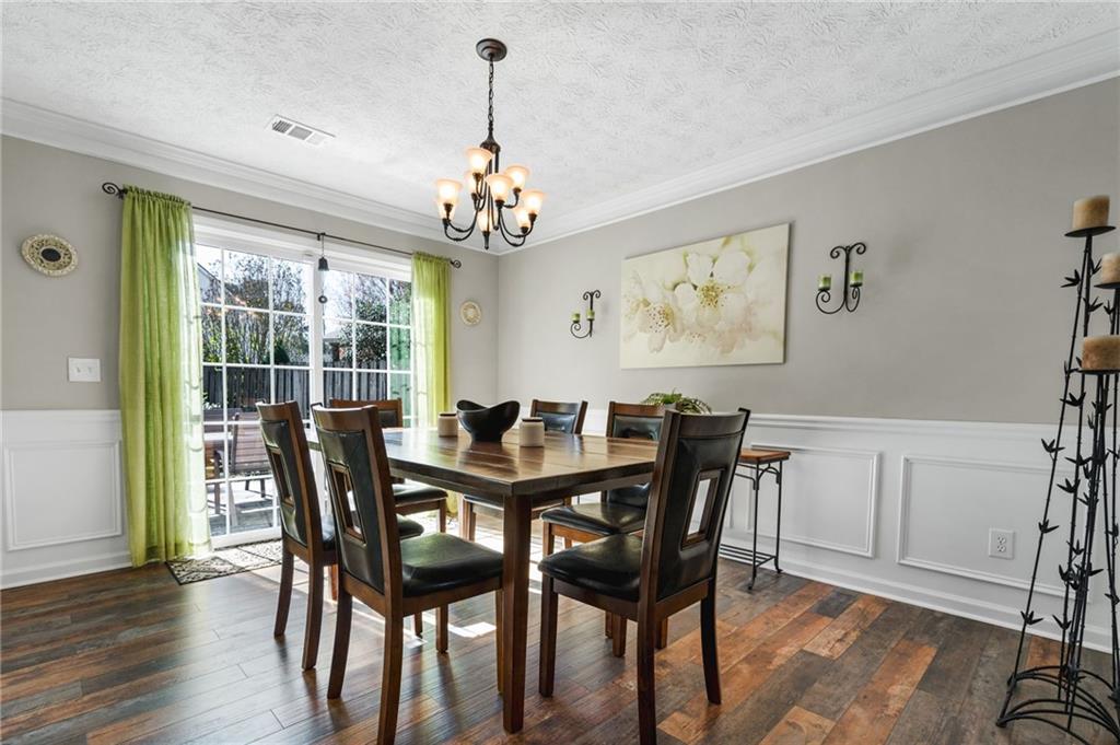 202 Weatherstone Crossing Woodstock, GA 30188 - Photo 9 of 29 a view of a dining room with furniture window and wooden floor