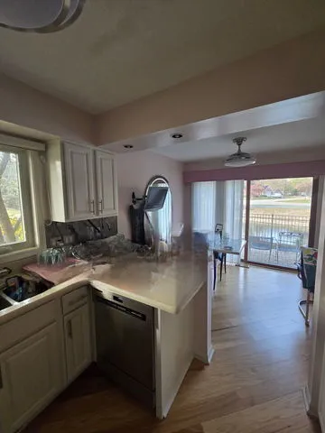 a kitchen with sink cabinets and dining table