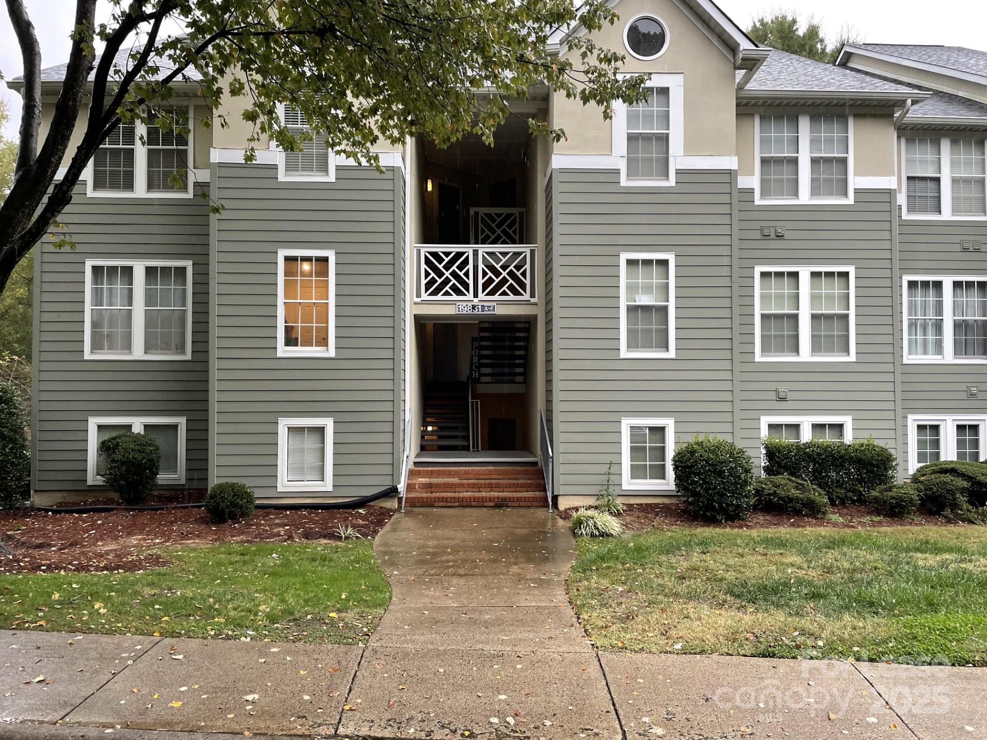 19831 Henderson Road, Unit E Cornelius, NC 28031 - Photo 1 of 23 a front view of a house with a yard