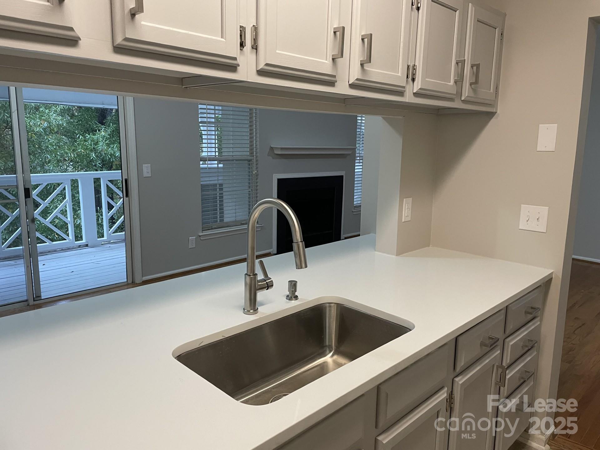 19831 Henderson Road, Unit E Cornelius, NC 28031 - Photo 13 of 23 a close view of a sink a faucet and appliance in the kitchen