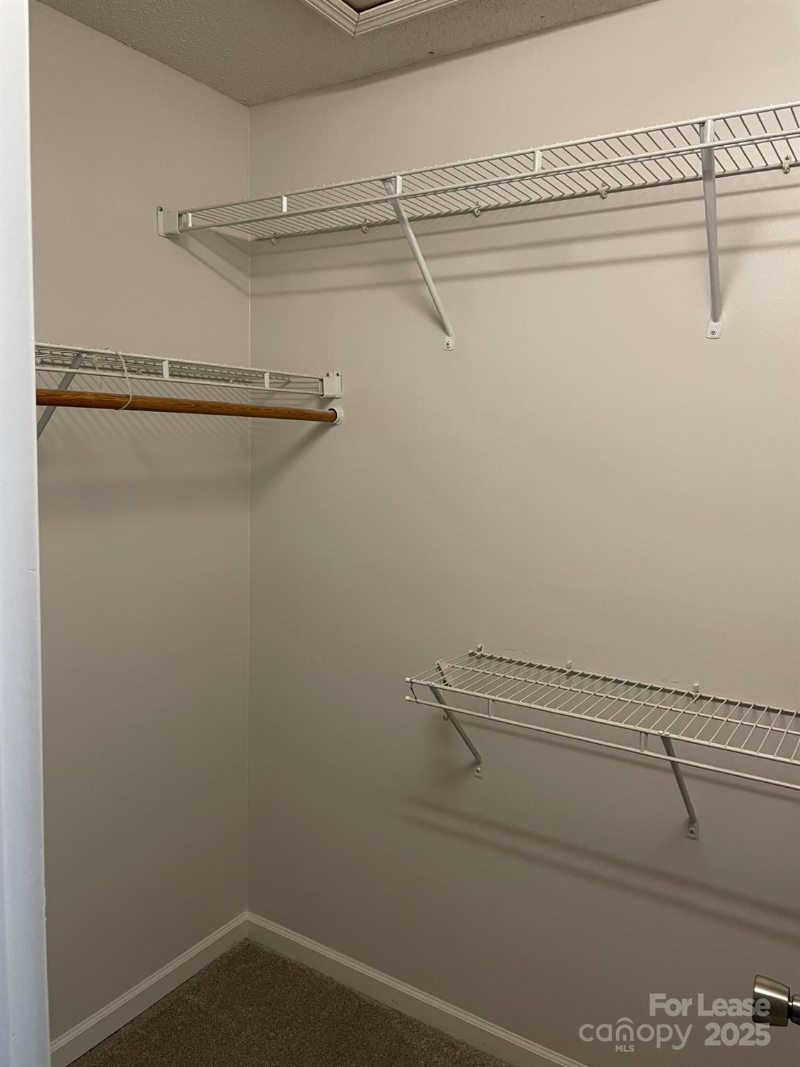 19831 Henderson Road, Unit E Cornelius, NC 28031 - Photo 17 of 23 a view of a room with racks on the wall