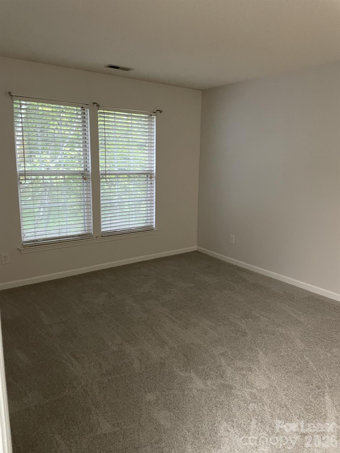 19831 Henderson Road, Unit E Cornelius, NC 28031 - Photo 17 of 27 an empty room with a window