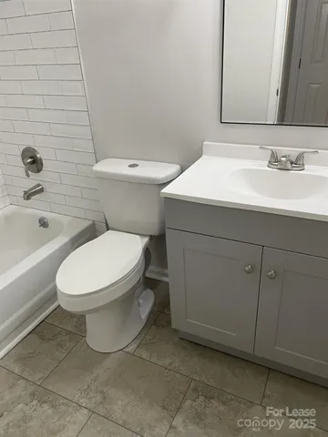 a white toilet sitting next to a bathroom sink