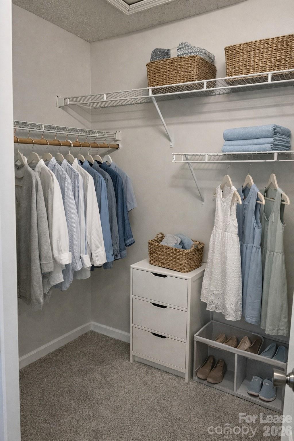 19831 Henderson Road, Unit E Cornelius, NC 28031 - Photo 20 of 27 a view of walk in closet with clothes and shoes
