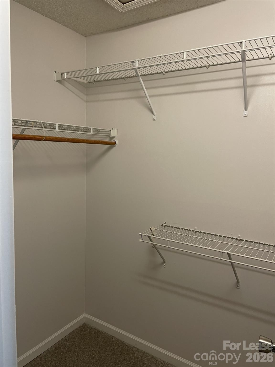 19831 Henderson Road, Unit E Cornelius, NC 28031 - Photo 21 of 27 a view of a room with racks on the wall