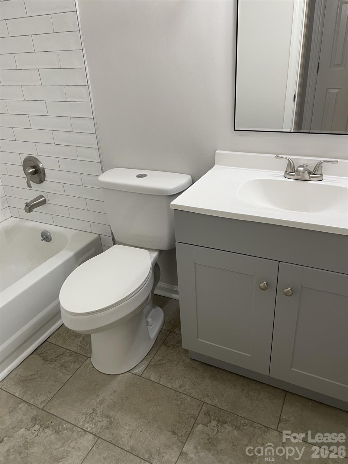 19831 Henderson Road, Unit E Cornelius, NC 28031 - Photo 22 of 27 a white toilet sitting next to a bathroom sink