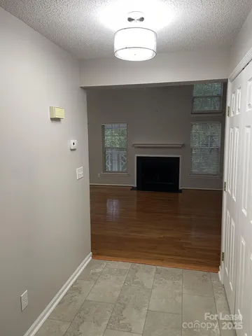 a view of a livingroom with a fireplace and cabinet
