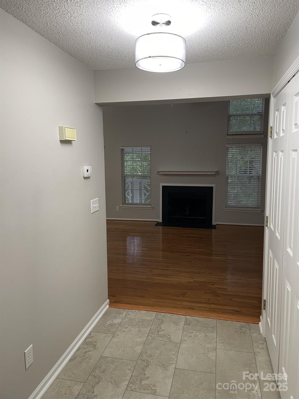 19831 Henderson Road, Unit E Cornelius, NC 28031 - Photo 3 of 23 a view of a livingroom with a fireplace and cabinet