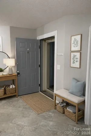 a view of a room with wooden floor and a ceiling fan