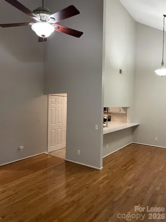 an empty room with wooden floor and staircase