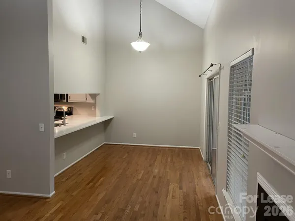 a kitchen with white cabinets and appliances