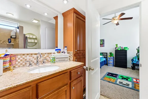 a bathroom with a sink a vanity and a mirror