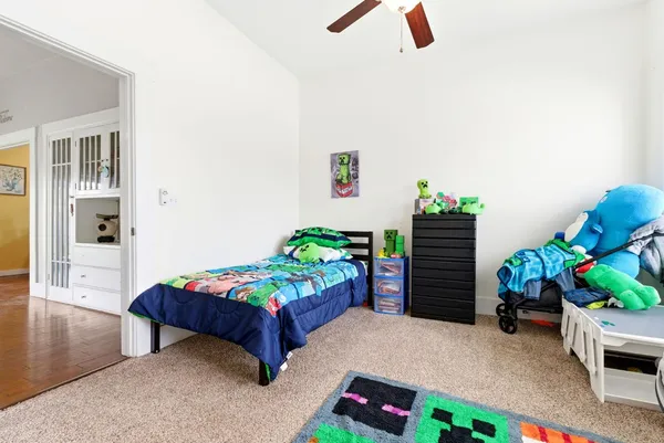 a bedroom with a bed and a potted plant