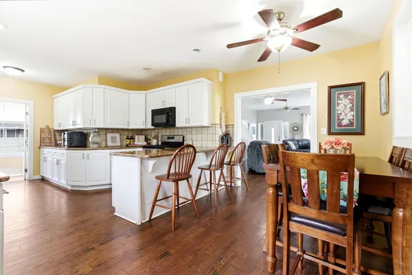 a kitchen with stainless steel appliances granite countertop a stove and a refrigerator
