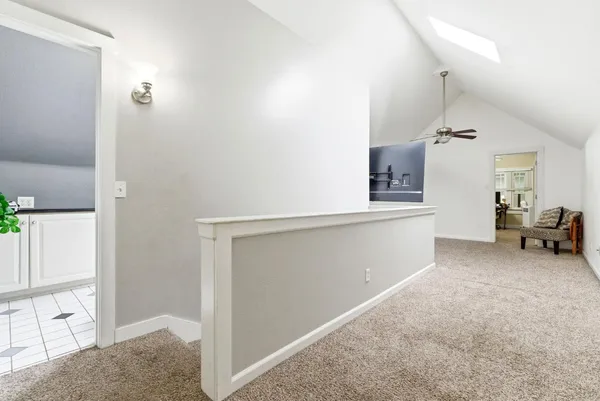 a view of an empty room with a ceiling fan