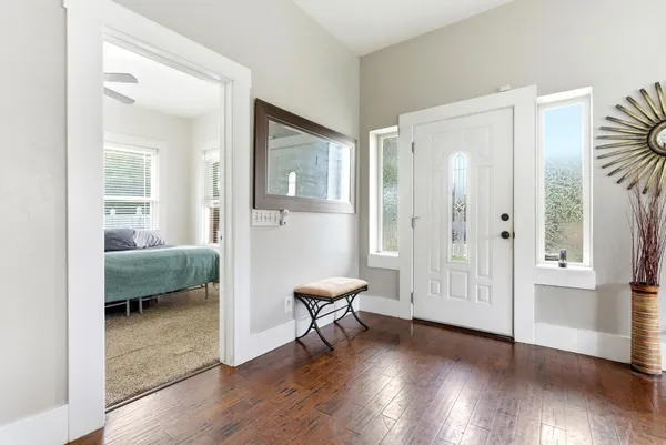 a bedroom with furniture and a wooden floor