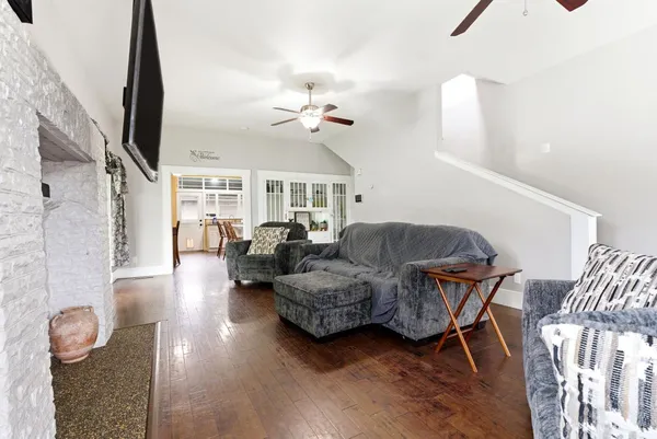 a living room with furniture flowerpot and wooden floor
