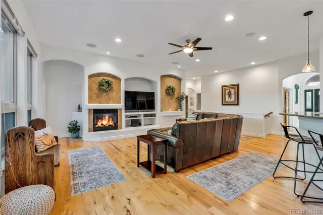 a living room with furniture and wooden floor