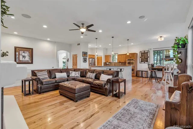 a view of a roof deck with table and chairs and wooden floor