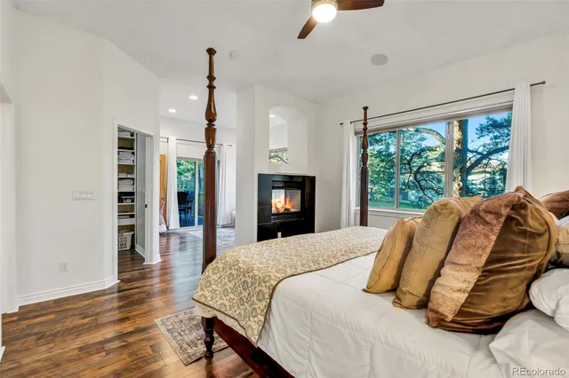 a bedroom with a large bed and a flat screen tv