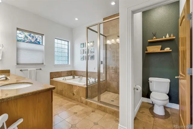 a view of a bedroom with a window and a ceiling fan