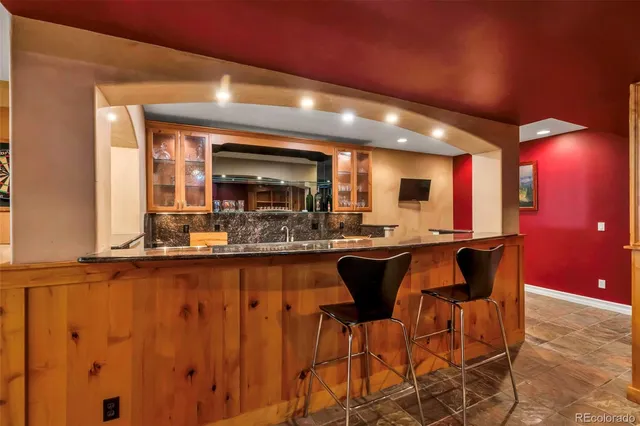 a view of kitchen with furniture a flat screen tv and kitchen view