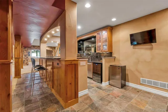 a kitchen with stainless steel appliances granite countertop a sink and a stove